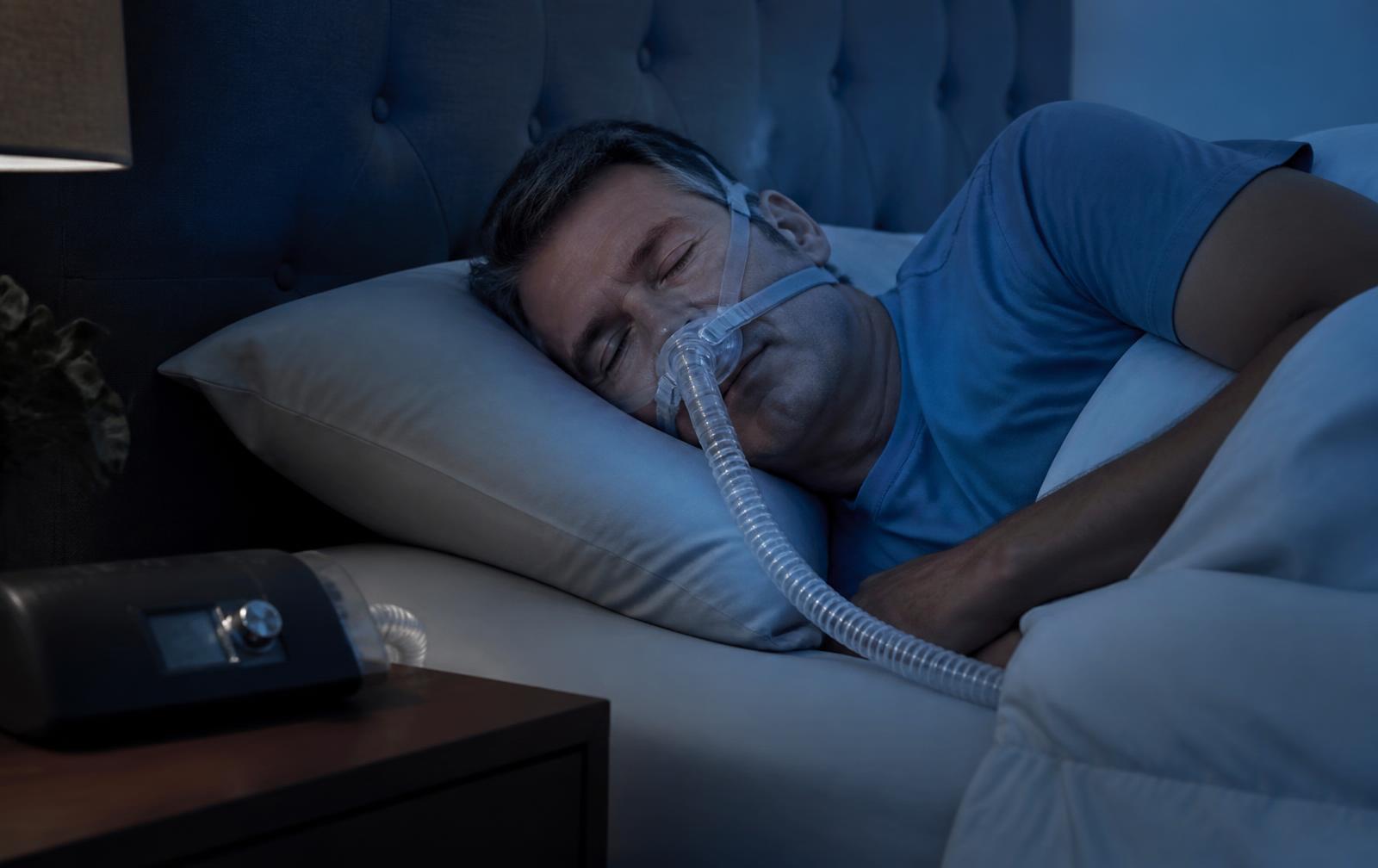 A person sleeping peacefully using a CPAP device